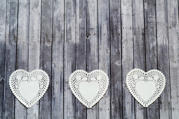 three lace doily on wood table for valentines day - obrazy, fototapety, plakaty