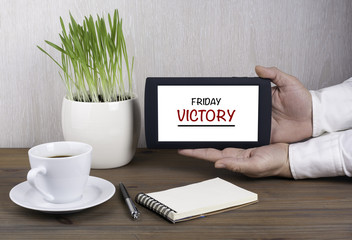 Digital tablet computer in male hands - Friday, Victory
