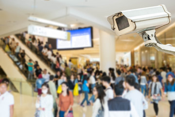 CCTV camera or surveillance operating with crowded people in bac