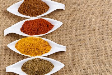 Cinnamon sticks with cinnamon powder on wooden background, Selective focus