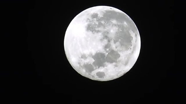 Super full moon light in clear night sky