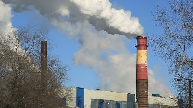 Factory, smoke and blue sky in winter morning