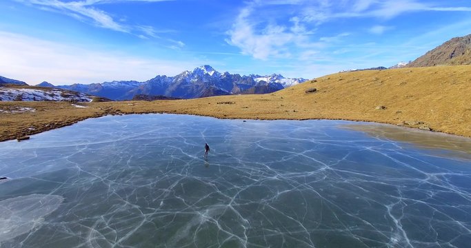 Aerial 4k - Skating on frozen lake