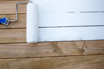 Applying undercoat on treated timber 