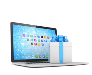 Gift box with ribbon bow on laptop keyboard