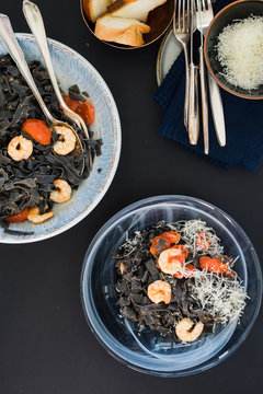 Black squid ink tagliatelle with tomatoes and shrimps