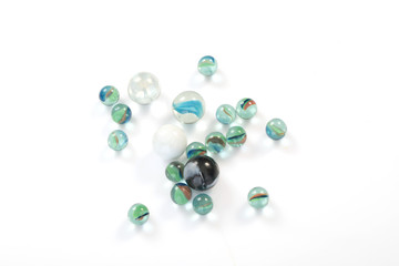 glass marbles balls on white blackground ,selective focus