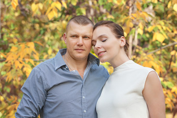 Fototapeta premium Happy husband embracing wife in autumn park