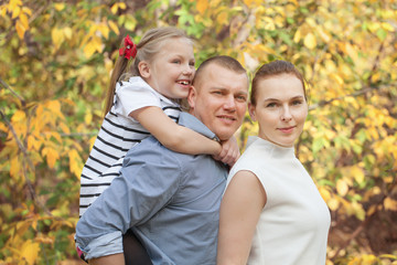 Portrait of happy family in fall park