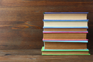 books in color cover folded stack on the wooden table