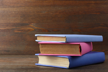 books in color cover folded stack on the wooden table