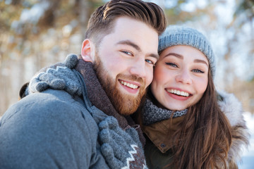 Smiling couple standing in winter park