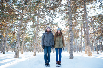 Fototapeta na wymiar Beautiful happy couple standing in winter park