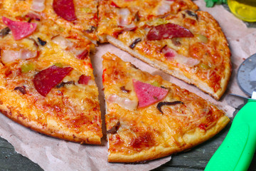 close-up Delicious Meat Pizza with Ham, Bacon and sausages on the wooden background
