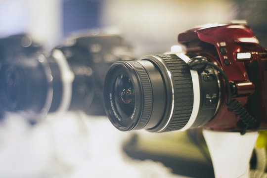 Photograph of a red reflex camera on a blurred background