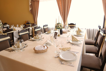 Elegant dinner table with flower bouquet and candle decorations