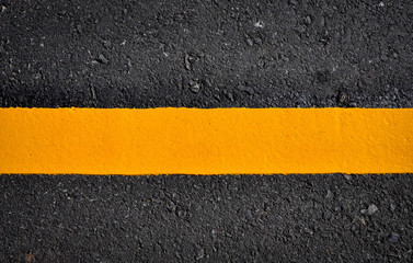 Fototapeta premium yellow line on asphalt road texture