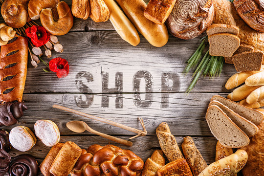breads, pastries, christmas cake on wooden background with letters, picture for bakery or shop