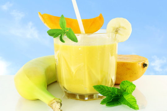 mango banana milkshake with stevia and mint in sky background
