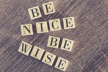 Be Nice Be Wise message formed with wooden blocks
