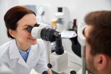 Fototapeta premium optician with tonometer and patient at eye clinic
