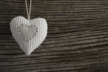Heart over a wooden background with space for text
