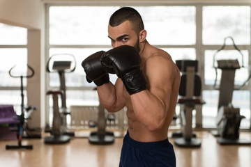 Naklejka na ściany i meble Young Athletic Man With Boxing Gloves