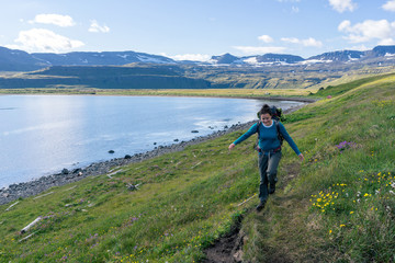 Woman hiking in most the isolated icelandic national park - Hornstrandir.
