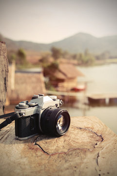 Vintage camera with view of lake and mountain