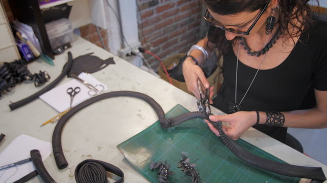 Young eco jewelry maker creating fashion accessories in her atelier