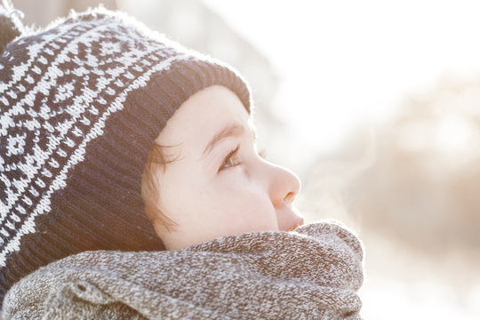 Little Boy Looking Up The Sky In Winter