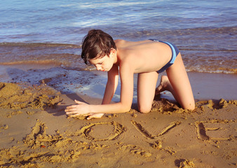 boy on the beach take sun bathing play with sand © ulianna19970