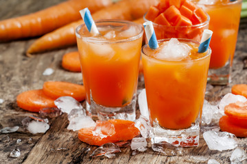 Fresh cold carrot juice with ice, selective focus