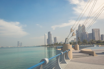 Park on the seafront against the backdrop of Abu Dhabi buildings