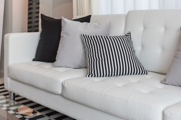 black and grey pillows on modern white sofa