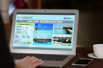 Woman using laptop to book hotel online