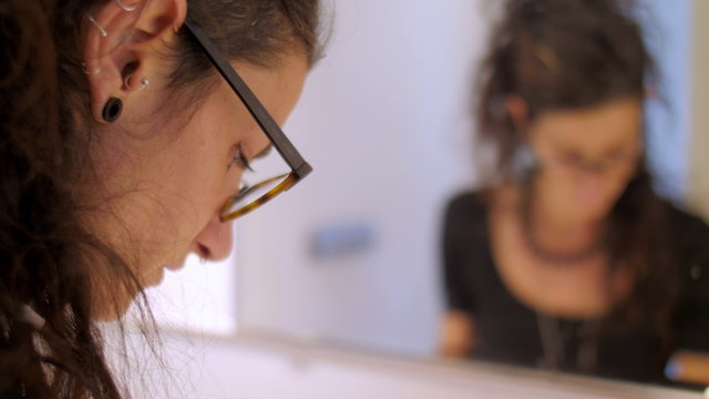 Young eco jewelry maker creating fashion accessories in her atelier