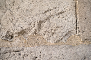 Texture with cracks of light brown stone