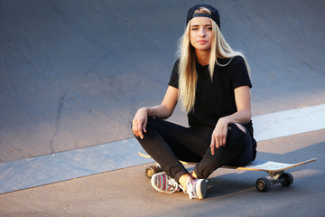 Young woman with skating board on the road © Africa Studio