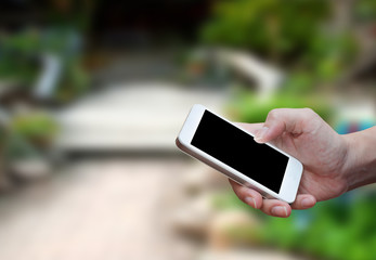 Man's hand shows mobile smartphone in vertical position
