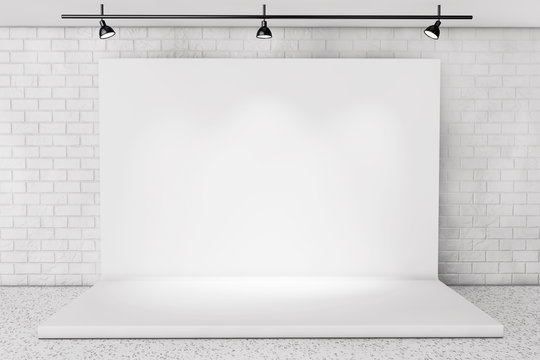 White Backdrop Stage in Room with Brick Wall