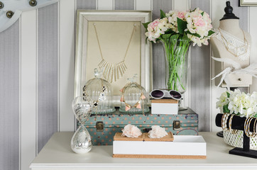 women's accesories on white dressing table
