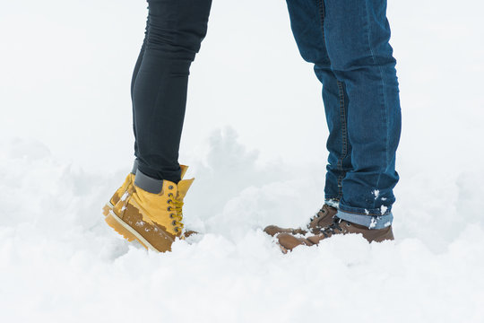 Young Couple In Winter Boots Standing On Snow