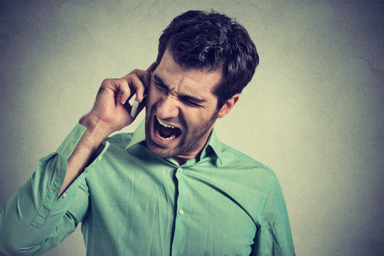 Angry businessman screaming on the mobile phone