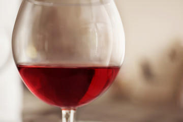 Glass of red wine on blurred background