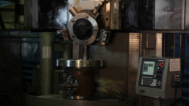 Industrial lathe works in factory