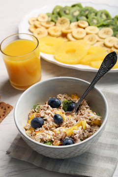 Tasty oatmeal and fruits on wooden background. Healthy eating concept.