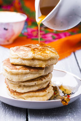 stack of hot pancakes with buckthorn syrup