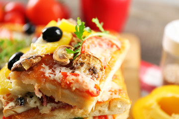 Pieces of delicious pizza on the table, close-up