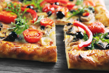 Freshly homemade pizza on wooden table closeup